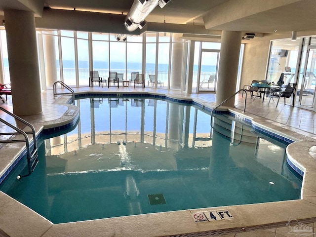 view of pool with a water view and a jacuzzi