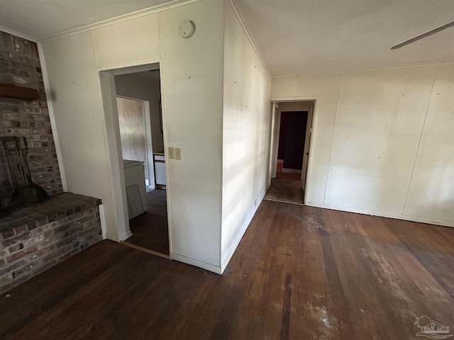 empty room with crown molding, baseboards, and wood finished floors