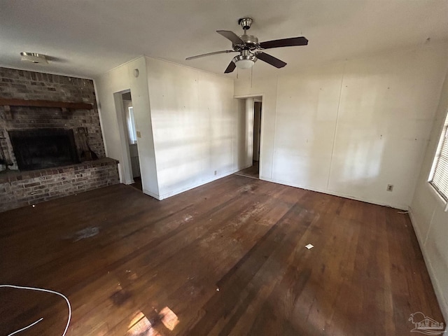 unfurnished living room featuring a fireplace, a ceiling fan, and wood finished floors