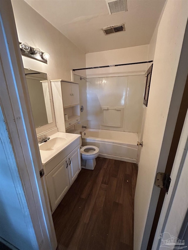 bathroom featuring toilet, visible vents, wood finished floors, and vanity