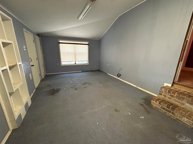 spare room featuring vaulted ceiling