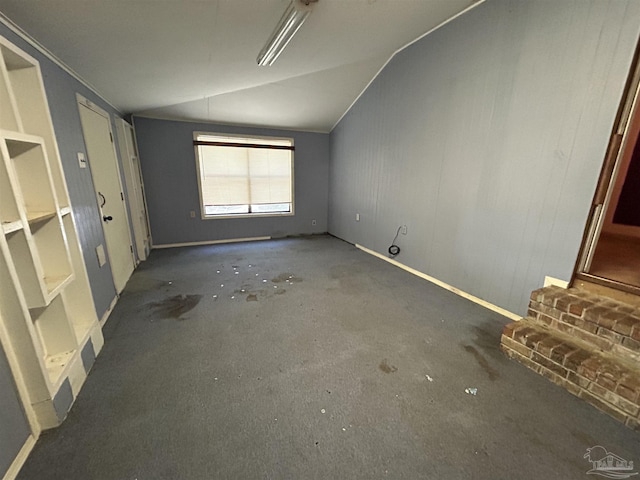 unfurnished bedroom with crown molding and vaulted ceiling