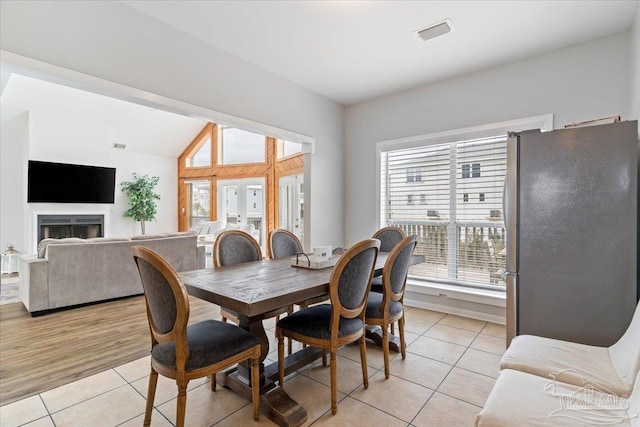 tiled dining space featuring french doors