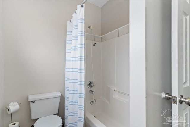 bathroom with shower / bath combo and toilet