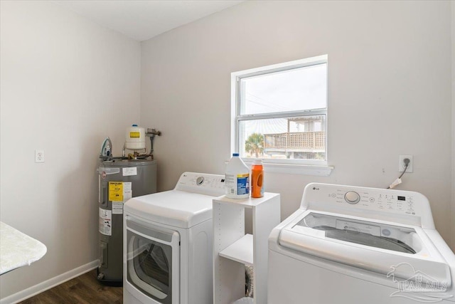 laundry room featuring dark hardwood / wood-style floors, water heater, and washing machine and clothes dryer