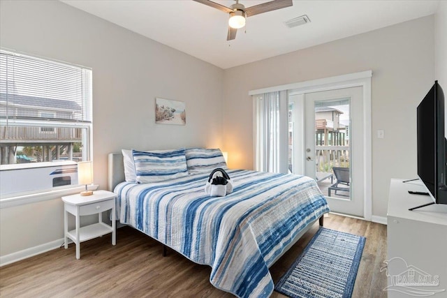 bedroom with wood-type flooring, ceiling fan, and access to outside