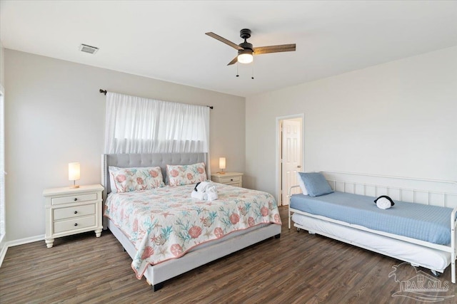 bedroom with ceiling fan and dark hardwood / wood-style floors