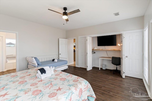 bedroom featuring ceiling fan, dark wood-type flooring, and ensuite bathroom