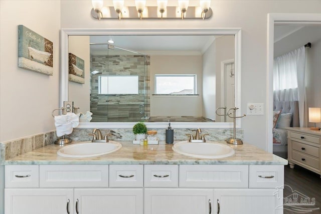 bathroom featuring vanity, ornamental molding, an enclosed shower, and hardwood / wood-style floors