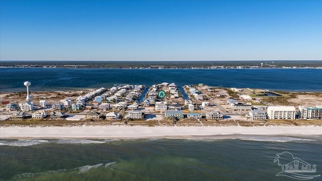 birds eye view of property featuring a water view and a beach view