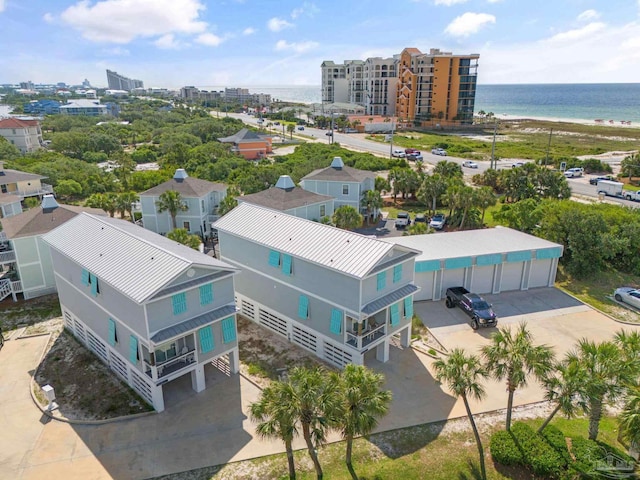 aerial view with a water view and a beach view