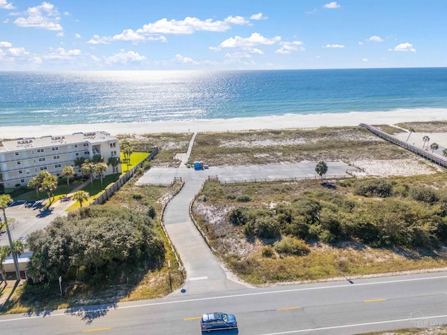 birds eye view of property featuring a water view and a beach view