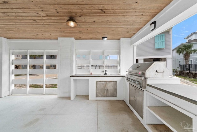 view of patio featuring area for grilling and sink