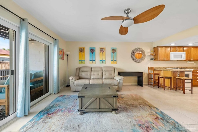 tiled living room with ceiling fan