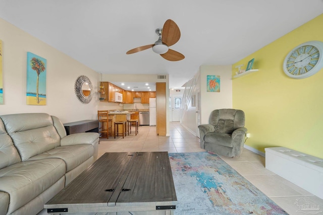 tiled living room with ceiling fan