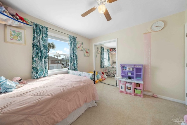 carpeted bedroom featuring a closet and ceiling fan