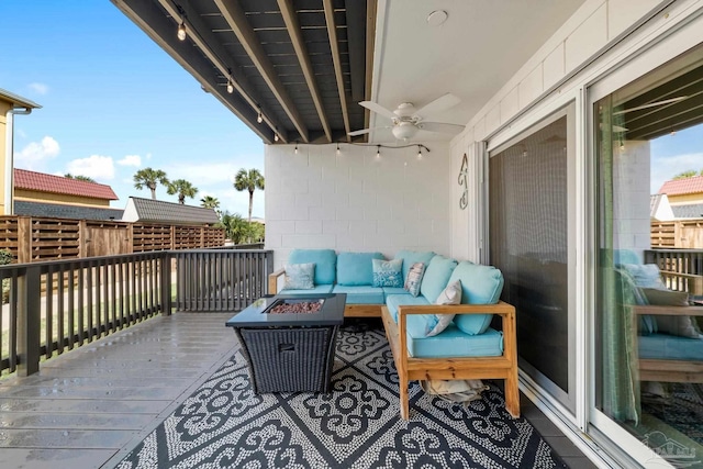 balcony featuring an outdoor living space with a fire pit and ceiling fan