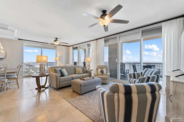 375 Beach Club Trl Unit A1801, Gulf Shores, AL 36542 - living area featuring a ceiling fan, a textured ceiling, light tile patterned floors, and floor to ceiling windows