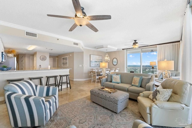 375 Beach Club Trl Unit A1801, Gulf Shores, AL 36542 - living area featuring ceiling fan, baseboards, a textured ceiling, crown molding, and light tile patterned floors