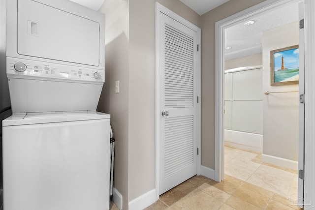 375 Beach Club Trl Unit A1801, Gulf Shores, AL 36542 - washroom with stacked washer and clothes dryer and baseboards