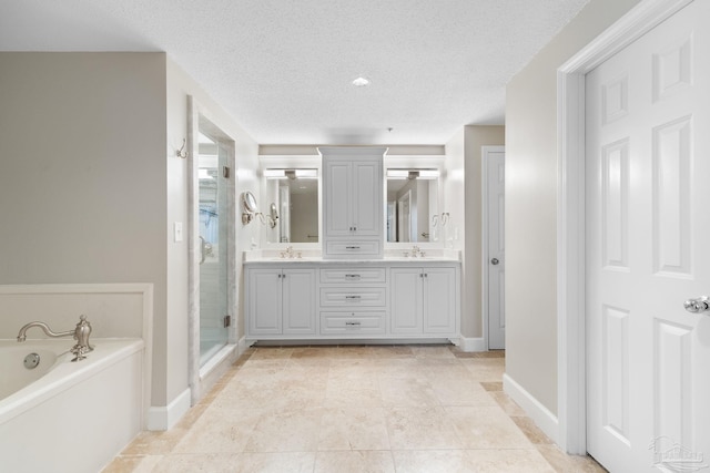 375 Beach Club Trl Unit A1801, Gulf Shores, AL 36542 - full bathroom with a garden tub, a shower stall, double vanity, baseboards, and a textured ceiling