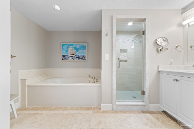 375 Beach Club Trl Unit A1801, Gulf Shores, AL 36542 - bathroom featuring a garden tub, vanity, a stall shower, and a textured ceiling