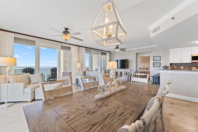 375 Beach Club Trl Unit A1801, Gulf Shores, AL 36542 - dining area with a ceiling fan, a textured ceiling, a chandelier, and crown molding