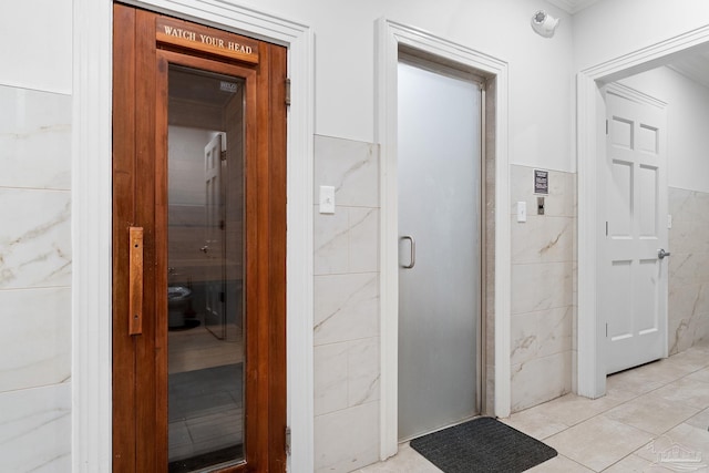 375 Beach Club Trl Unit A1801, Gulf Shores, AL 36542 - hallway featuring tile walls, a relaxing sauna, light tile patterned floors, and a wainscoted wall