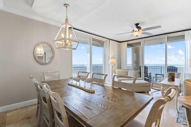 375 Beach Club Trl Unit A1801, Gulf Shores, AL 36542 - dining room featuring ceiling fan, baseboards, ornamental molding, a water view, and a textured ceiling