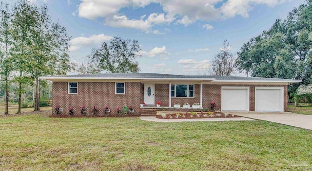 ranch-style house featuring a porch, a front yard, and a garage