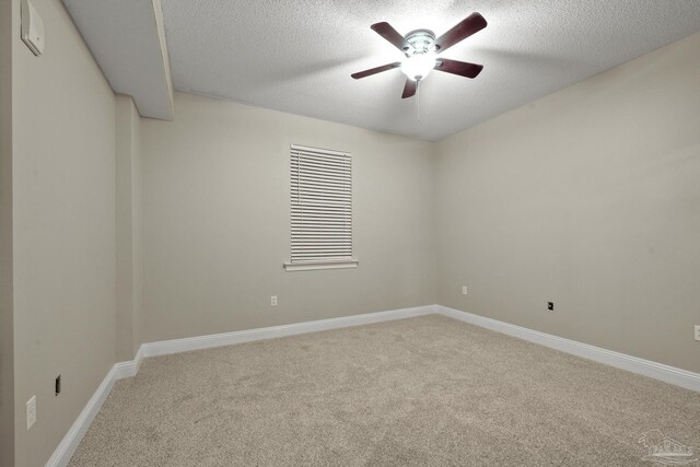 spare room with carpet flooring, a textured ceiling, and ceiling fan