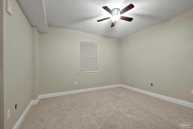 unfurnished room with ceiling fan, a textured ceiling, and carpet flooring