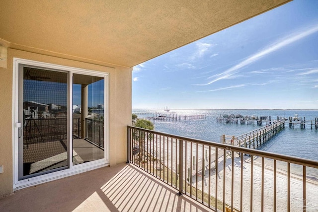 balcony with a dock and a water view