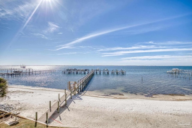 dock area featuring a water view and a view of the beach