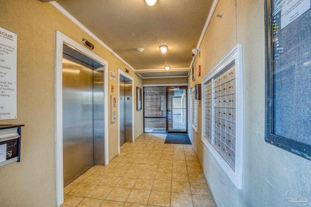 hall with ornamental molding, a mail area, elevator, and a textured ceiling