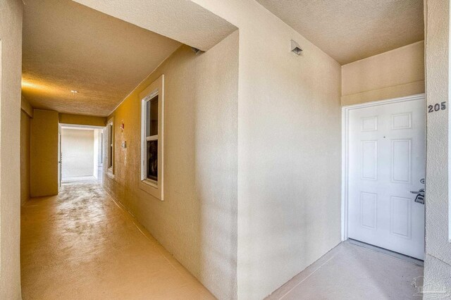 hallway with a textured ceiling