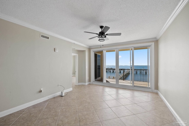 tiled spare room with a water view, ceiling fan, crown molding, and a textured ceiling