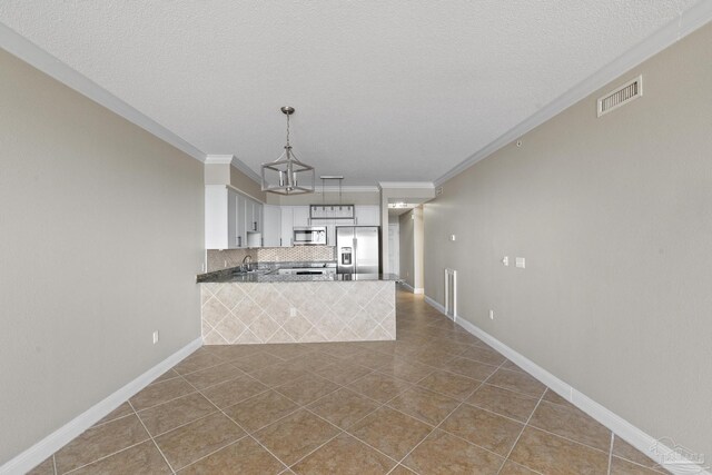 kitchen featuring crown molding, tasteful backsplash, stainless steel appliances, and light tile patterned floors