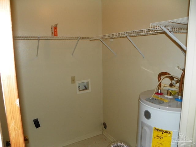 laundry room featuring hookup for a washing machine, laundry area, water heater, and baseboards