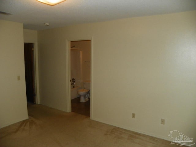 spare room with light colored carpet and visible vents