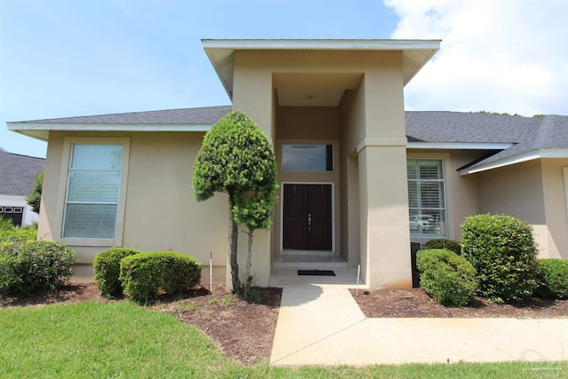 3756 Bengal Rd, Gulf Breeze, FL 32563 - view of exterior entry featuring roof with shingles and stucco siding