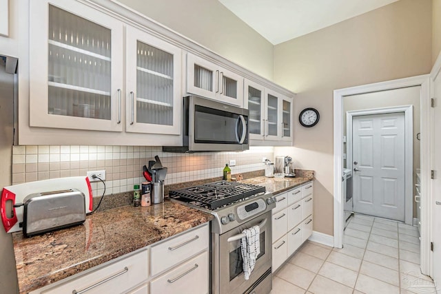 3756 Bengal Rd, Gulf Breeze, FL 32563 - kitchen with stainless steel appliances, stone counters, light tile patterned floors, tasteful backsplash, and glass insert cabinets