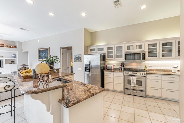 3756 Bengal Rd, Gulf Breeze, FL 32563 - kitchen with a breakfast bar area, visible vents, appliances with stainless steel finishes, a sink, and light tile patterned flooring