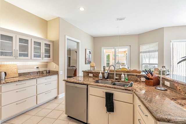 3756 Bengal Rd, Gulf Breeze, FL 32563 - kitchen with decorative backsplash, visible vents, stainless steel dishwasher, a sink, and light tile patterned flooring