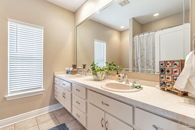 3756 Bengal Rd, Gulf Breeze, FL 32563 - bathroom featuring baseboards, visible vents, a sink, and tile patterned flooring