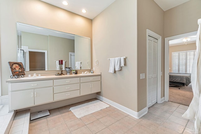 3756 Bengal Rd, Gulf Breeze, FL 32563 - bathroom featuring double vanity, baseboards, a sink, and a closet
