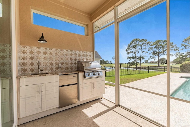 3756 Bengal Rd, Gulf Breeze, FL 32563 - view of patio / terrace featuring fence, exterior kitchen, a fenced in pool, a sink, and a grill