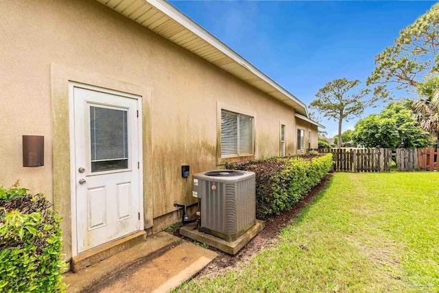 3756 Bengal Rd, Gulf Breeze, FL 32563 - view of home's exterior with central air condition unit, fence, stucco siding, and a yard
