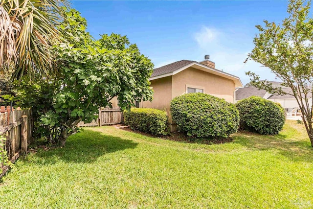 3756 Bengal Rd, Gulf Breeze, FL 32563 - view of property exterior with fence, a chimney, and a yard