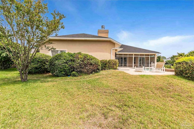 3756 Bengal Rd, Gulf Breeze, FL 32563 - back of house featuring a sunroom, a lawn, and a chimney